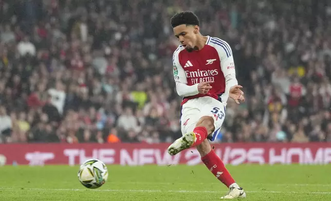 Arsenal's Ethan Nwaneri scores his side's the third goal during the English League Cup third round soccer match between Arsenal and Bolton Wanderers at the Emirates stadium in London, Wednesday, Sept. 25, 2024. (AP Photo/Kirsty Wigglesworth)