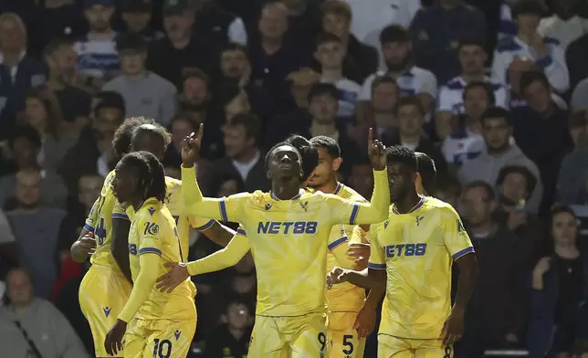 Crystal Palace's Eddie Nketiah, center, celebrates scoring during the English League Cup third round soccer match between Queens Park Rangers QPR and Crystal Palace at the Loftus Road Stadium, London, Tuesday Sept. 17, 2024. (Steven Paston/PA via AP)