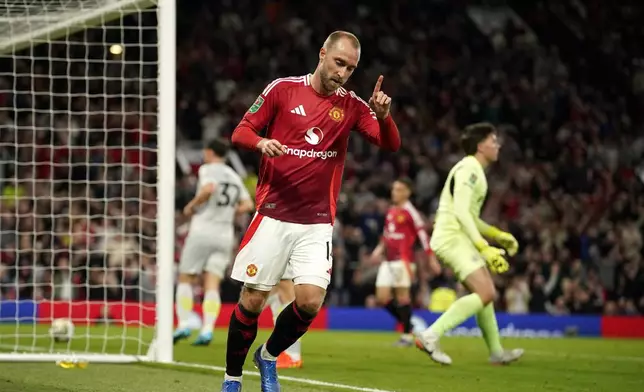 Manchester United's Christian Eriksen celebrates after scoring the 6th goal during the English League Cup soccer match between Manchester United and Barnsley at Old Trafford, Manchester, England, Tuesday, Sept. 17, 2024. (AP Photo/Dave Thompson)