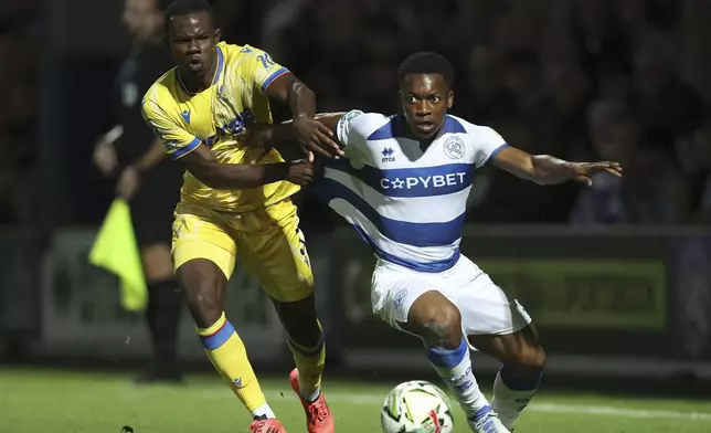 Queens Park Rangers' Karamoko Dembele, left, and Crystal Palace's Tyrick Mitchell in action during the English League Cup third round soccer match between Queens Park Rangers QPR and Crystal Palace at the Loftus Road Stadium, London, Tuesday Sept. 17, 2024. (Steven Paston/PA via AP)