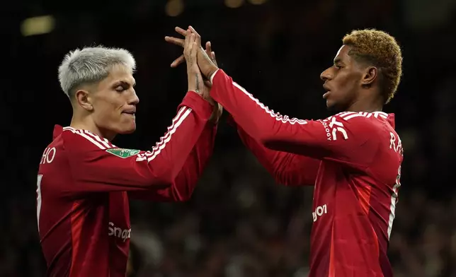 Manchester United's Marcus Rashford celebrates with Manchester United's Alejandro Garnacho, left, after scoring the fifth goal during the English League Cup soccer match between Manchester United and Barnsley at Old Trafford, Manchester, England, Tuesday, Sept. 17, 2024. (AP Photo/Dave Thompson)