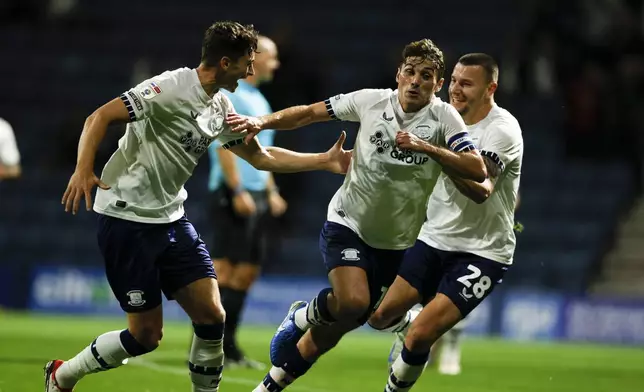 Preston North End's Ryan Ledson, center, celebrates scoring during the English League Cup third round soccer match between Preston and Fulham at Deepdale, Preston, England, Tuesday Sept. 17, 2024. (Richard Sellers/PA via AP)