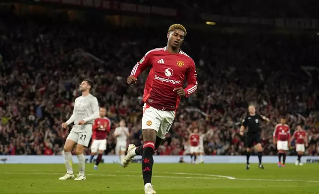 Manchester United's Marcus Rashford after scoring the fifth goal during the English League Cup soccer match between Manchester United and Barnsley at Old Trafford, Manchester, England, Tuesday, Sept. 17, 2024. (AP Photo/Dave Thompson)