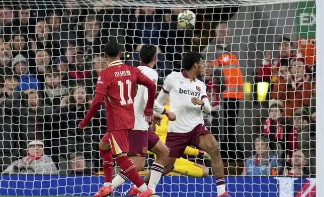 Liverpool's Mohamed Salah scores his side's third goal during the English League Cup soccer match between Liverpool and West Ham United at Anfield Stadium, Liverpool, England, Wednesday, Sept. 25, 2024. (AP Photo/Jon Super)