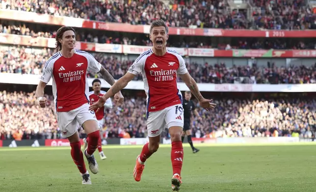 Arsenal's Leandro Trossard celebrates after scoring his side's fourth goal during the English Premier League soccer match between Arsenal and Leicester City at the Emirates Stadium in London, Saturday, Sept. 28, 2024. (AP Photo/Ian Walton)
