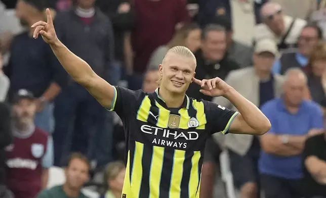 Manchester City's Erling Haaland celebrates after scoring his side's second goal during the English Premier League soccer match between West Ham United and Manchester City at the London Stadium in London, England, Saturday, Aug. 31, 2024. (AP Photo/Frank Augstein)