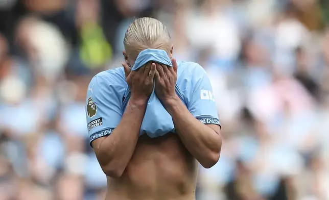 Manchester City's Erling Haaland wipes sweat from his face during the English Premier League soccer match between Manchester City and Brentford at the Etihad Stadium in Manchester, England, Saturday, Sept. 14, 2024. (AP Photo/Scott Heppel)