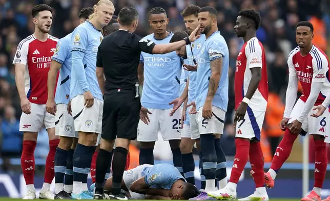 Manchester City's Rodri lays on the pitch after collision during the English Premier League soccer match between Manchester City and Arsenal at the Etihad stadium in Manchester, England, Sunday, Sept. 22, 2024. (AP Photo/Dave Thompson)