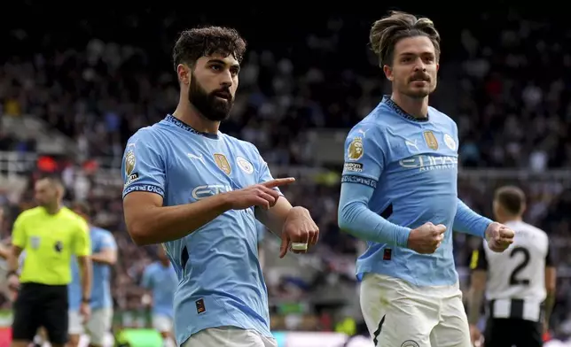 Manchester City's Josko Gvardiol, left, celebrates with teammate Jack Grealish after scoring his side's first goal during the Premier League match between Newcastle and Manchester City, at St James' Park, Newcastle upon Tyne, England, Saturday Sept. 28, 2024. (Owen Humphreys/PA via AP)