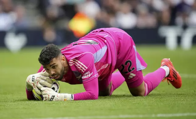 Arsenal's goalkeeper David Raya claims the ball during the English Premier League soccer match between Tottenham Hotspur and Arsenal in London, Sunday, Sept. 15, 2024. (AP Photo/Kin Cheung)