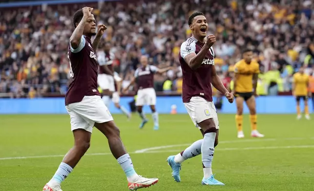 Aston Villa's Ollie Watkins, right, celebrates scoring during the English Premier League soccer match between Aston Villa and Wolverhampton Wanderers at Villa Park, Birmingham, England, Saturday Sept. 21, 2024. (Martin Rickett/PA via AP)