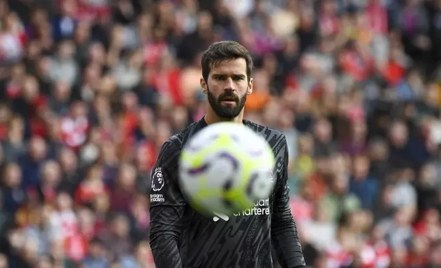 Liverpool's goalkeeper Alisson looks the ball during the English Premier League soccer match between Liverpool and Nottingham Forest at Anfield Stadium in Liverpool, England, Saturday, Sept. 14, 2024. (AP Photo/Rui Vieira)