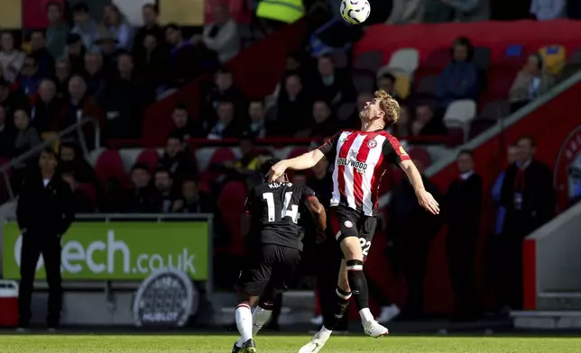 Brentford's Nathan Collins battles for the ball against West Ham United's Mohammed Kudus during the British Premier League soccer match between West Ham and Brentford, at the Gtech Community Stadium, London, Saturday Sept. 28, 2024. (Rhianna Chadwick/PA via AP)