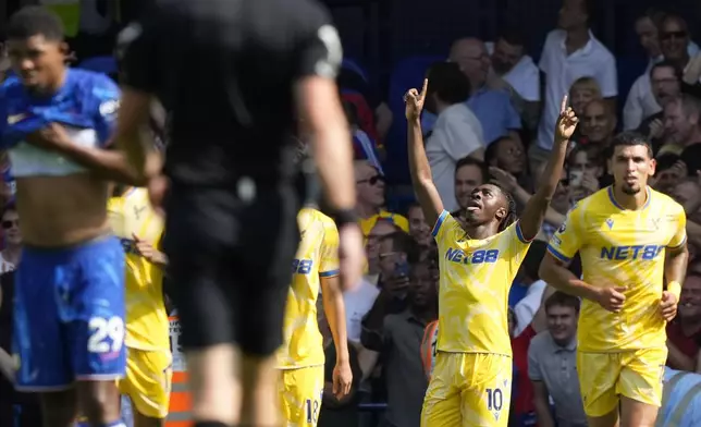 Crystal Palace's Eberechi Eze, second right, celebrates after scoring his sides first goal during the English Premier League soccer match between Chelsea and Crystal Palace, at the Stamford Bridge Stadium in London, Sunday, Sept. 1, 2024. (AP Photo/Frank Augstein)