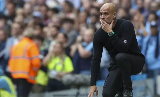 Manchester City's head coach Pep Guardiola reacts during the English Premier League soccer match between Manchester City and Brentford at the Etihad Stadium in Manchester, England, Saturday, Sept. 14, 2024. (AP Photo/Scott Heppel)