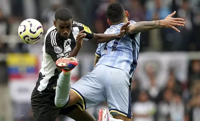 Newcastle United's Alexander Isak, left, and Tottenham Hotspur's Cristian Romero battle for the ball during the Englidh Premier League soccer match between Newcastle United and Tottenham Hotspur at St James' Park, Newcastle, England, Sunday Sept. 1, 2024. (Owen Humphreys/PA via AP)