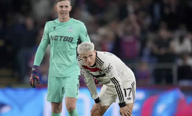 Manchester United's Alejandro Garnacho and Crystal Palace's goalkeeper Dean Henderson, left, react at the end of the English Premier League soccer match between Crystal Palace and Manchester United at Selhurst Park in London, Saturday, Sept. 21, 2023. (AP Photo/Kin Cheung)