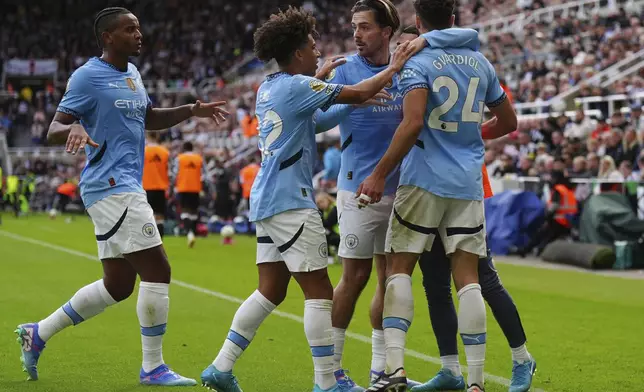 Manchester City's Josko Gvardiol, right, celebrates with teammates after scoring their side's first goal during the Premier League match between Newcastle and Manchester City, at St James' Park, Newcastle upon Tyne, England, Saturday Sept. 28, 2024. (Owen Humphreys/PA via AP)