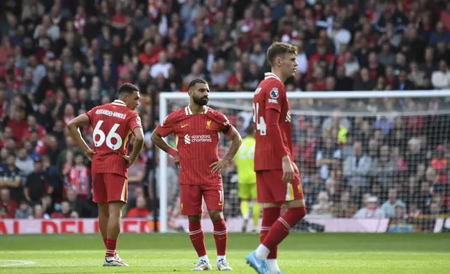 Liverpool's players react after Nottingham Forest's Callum Hudson-Odoi scoring during the English Premier League soccer match between Liverpool and Nottingham Forest at Anfield Stadium in Liverpool, England, Saturday, Sept. 14, 2024. (AP Photo/Rui Vieira)