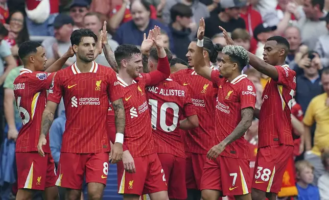 Liverpool's Luis Diaz, second right, celebrates scoring his side's second goal of the game, during the English Premier League soccer match between Liverpool and Bournemouth, at Anfield, in Liverpool, England, Saturday, Sept. 21, 2024. (Peter Byrne/PA via AP)