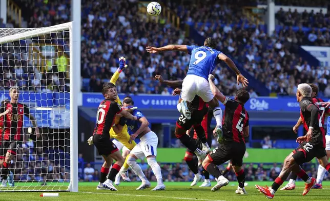 Everton's Dominic Calvert-Lewin, center, heads the ball during the English Premier League soccer match between Everton and Bournemouth at Goodison Park, Liverpool, England, Saturday Aug. 31, 2024. (Peter Byrne/PA via AP)