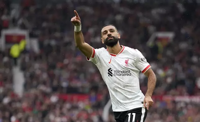 Liverpool's Mohamed Salah celebrates after scoring his side's third goal during the English Premier League soccer match between Manchester United and Liverpool at Old Trafford, Sunday, Sept. 1, 2024, in Manchester, England. (AP Photo/Dave Thompson)