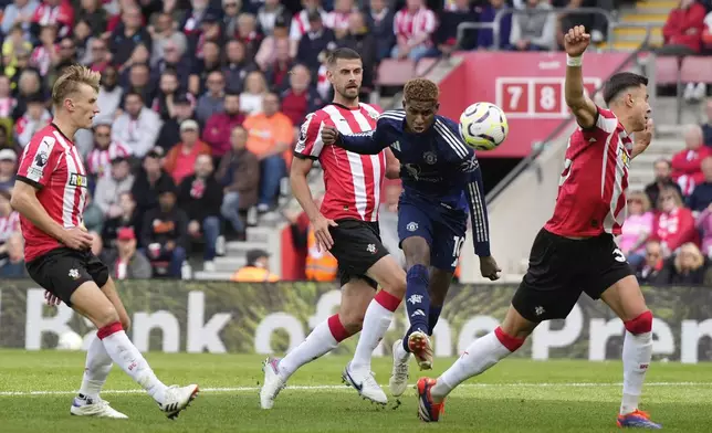 Manchester United's Marcus Rashford, center, takes a shot during the English Premier League soccer match between Southampton and Manchester United at St. Mary's stadium in Southampton, England, Saturday, Sept. 14, 2024. (AP Photo/Alastair Grant)