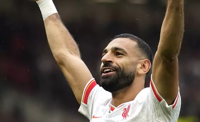 Liverpool's Mohamed Salah celebrates after scoring his side's third goal during the English Premier League soccer match between Manchester United and Liverpool at Old Trafford, Sunday, Sept. 1, 2024, in Manchester, England. (AP Photo/Dave Thompson)