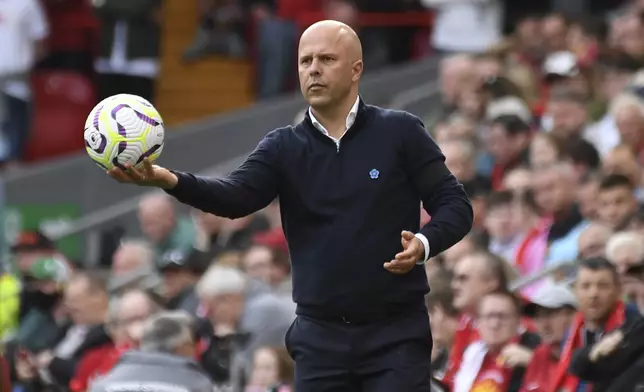 Liverpool's manager Arne Slot holds a ball during the English Premier League soccer match between Liverpool and Nottingham Forest at Anfield Stadium in Liverpool, England, Saturday, Sept. 14, 2024. (AP Photo/Rui Vieira)