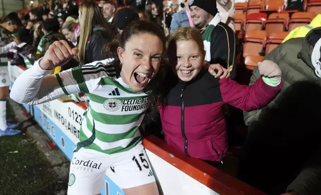 Celtic's Kelly Clark, left, celebrates with fans after a women's Champions League soccer match against Vorskla Poltava at the Albert Bartlett Stadium in Airdrie, Scotland, Thursday Sept. 26, 2024. (Andrew Milligan/PA via AP)