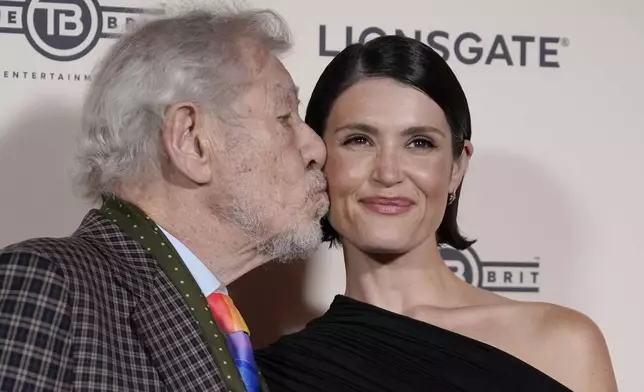 Ian McKellen, kisses co-star Gemma Arterton, as they pose for photographers upon arrival at the European Premiere of the The Critic, In London, Monday, Sept. 2, 2024. (AP Photo/Alberto Pezzali)