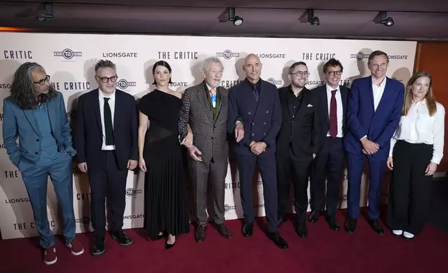 Ian McKellen, with Gemma Arterton, at centre, with cast members as they pose for photographers upon arrival at the European Premiere of the The Critic, In London, Monday, Sept. 2, 2024. (AP Photo/Alberto Pezzali)