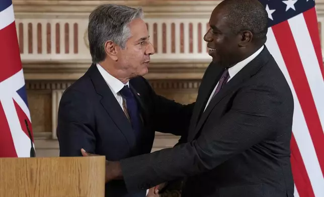 Secretary of State Antony Blinken, left and Britain's Foreign Secretary David Lammy shake hands at the end of their joint press conference in the Locarno room at the Foreign, Commonwealth and Development Office (FCDO) in London, Tuesday, Sept. 10, 2024. (AP Photo/Alberto Pezzali, Pool)