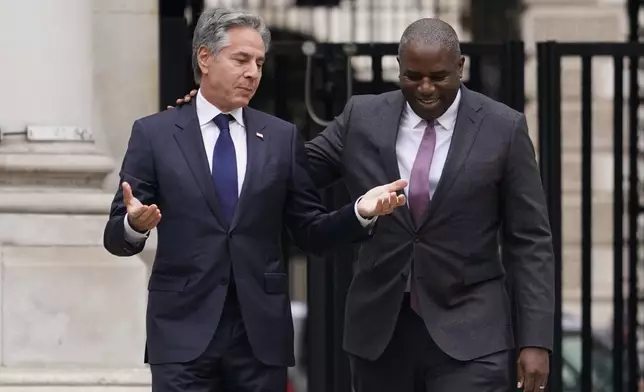 Secretary of State Antony Blinken, left, speaks to Britain's Foreign Secretary David Lammy as he arrives for a meeting at the Foreign, Commonwealth and Development Office (FCDO) in London, Tuesday, Sept. 10, 2024. (AP Photo/Alberto Pezzali, Pool)