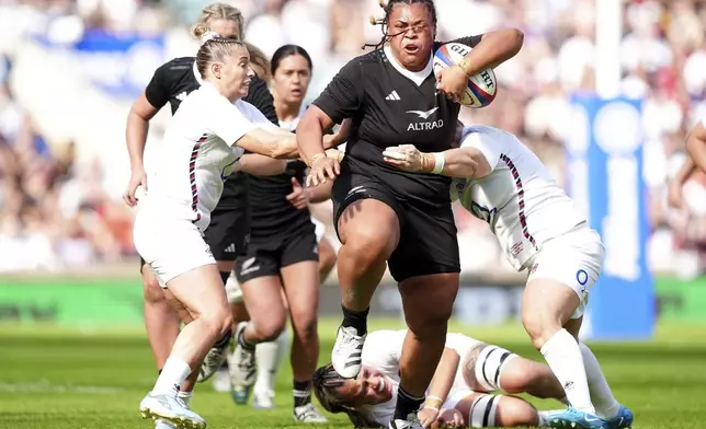 New Zealand's Tanya Kalounivale, center, is tackled by England's Natasha Hunt and Marlie Packer during the Women's International match between England and New Zealand at Allianz Stadium, Twickenham, London, Saturday Sept. 14, 2024. (David Davies/PA via AP)