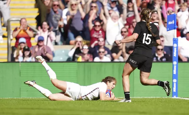 England's Abby Dow scores their side's second try of the game during the Women's International match between England and New Zealand at Allianz Stadium, Twickenham, London, Saturday Sept. 14, 2024. (David Davies/PA via AP)