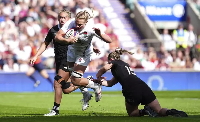 England's Alex Matthews is tackled by New Zealand's Renee Holmes, right, during the Women's International match between England and New Zealand at Allianz Stadium, Twickenham, London, Saturday Sept. 14, 2024. (David Davies/PA via AP)