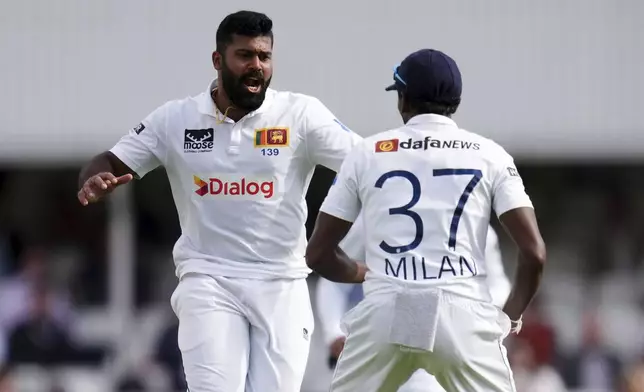 Sri Lanka's Lahiru Kumara, left, celebrates taking the wicket of England's Chris Woakes during day three of the Third Rothesay Men's Test cricket match between England and Sri Lanka in London, England, Sunday, Sept. 8, 2024. (John Walton/PA via AP)