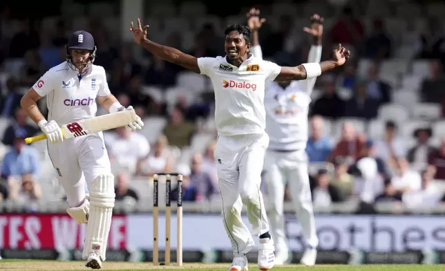 Sri Lanka's Vishwa Fernando, front right, successfully appeals for the wicket of England's Joe Root, left, during day three of the Third Rothesay Men's Test cricket match between England and Sri Lanka in London, England, Sunday, Sept. 8, 2024. (John Walton/PA via AP)