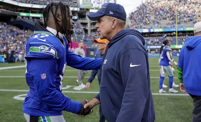 Denver Broncos head coach Sean Payton shakes hands with Seattle Seahawks linebacker Jerome Baker (17) after an NFL football game Sunday, Sept. 8, 2024, in Seattle. The Seattle Seahawks won 26-20. (AP Photo/John Froschauer)