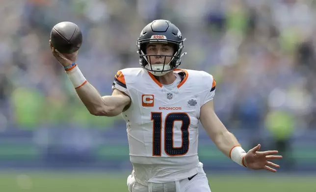 Denver Broncos quarterback Bo Nix (10) throws during the first half of an NFL football game against the Seattle Seahawks, Sunday, Sept. 8, 2024, in Seattle. (AP Photo/John Froschauer)