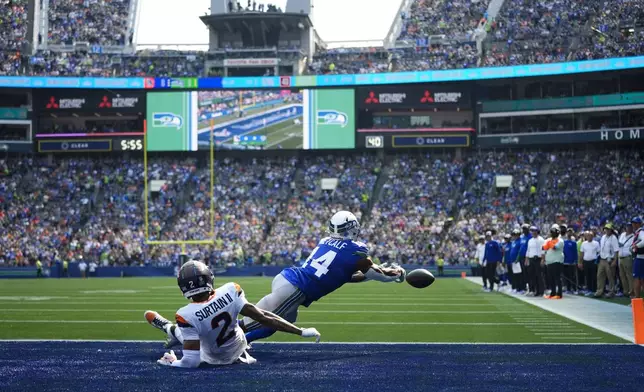 Seattle Seahawks wide receiver DK Metcalf (14) is unable to catch a two-point conversion as Denver Broncos cornerback Pat Surtain II (2) looks on during the first half of an NFL football game Sunday, Sept. 8, 2024, in Seattle. (AP Photo/Lindsey Wasson)