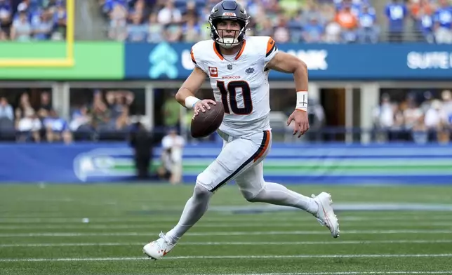 Denver Broncos quarterback Bo Nix (10) runs for a touchdown during the second half of an NFL football game against the Seattle Seahawks, Sunday, Sept. 8, 2024, in Seattle. (AP Photo/Lindsey Wasson)