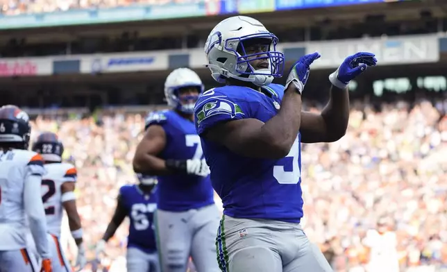 Seattle Seahawks running back Kenneth Walker III (9) reacts after scoring a touchdown during the second half of an NFL football game against the Denver Broncos, Sunday, Sept. 8, 2024, in Seattle. (AP Photo/Lindsey Wasson)