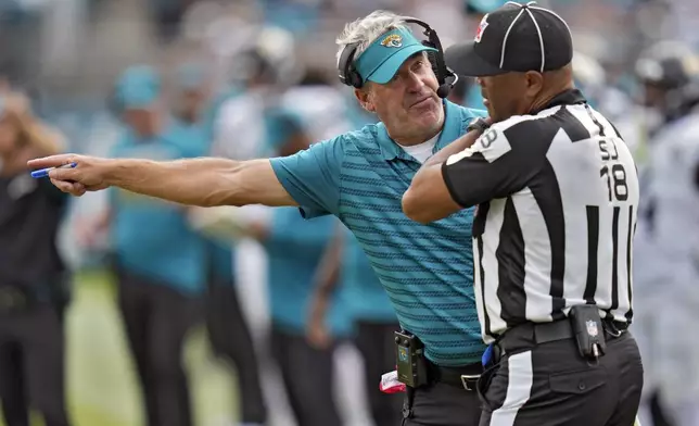 Jacksonville Jaguars head coach Doug Pederson questions side judge Clay Reynard (18) during the second half of an NFL football game against the Cleveland Browns Sunday, Sept. 15, 2024, in Jacksonville, Fla. (AP Photo/John Raoux)