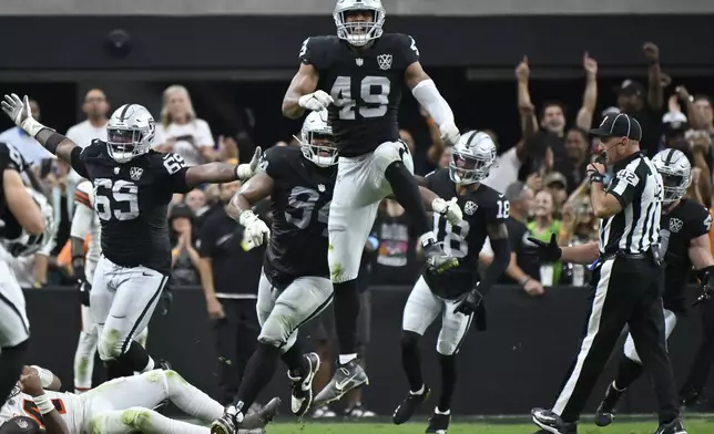 Las Vegas Raiders defensive end Charles Snowden, center, celebrates after sacking Cleveland Browns quarterback Deshaun Watson, below left, during the second half of an NFL football game Sunday, Sept. 29, 2024, in Las Vegas. (AP Photo/David Becker)