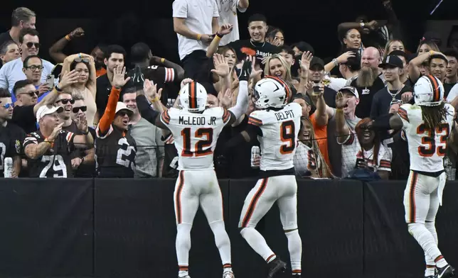 Cleveland Browns safety Rodney McLeod Jr. (12) celebrates with teammates and fans after scoring a touchdown off a fumble recovery during the second half of an NFL football game against the Las Vegas Raiders Sunday, Sept. 29, 2024, in Las Vegas. (AP Photo/David Becker)