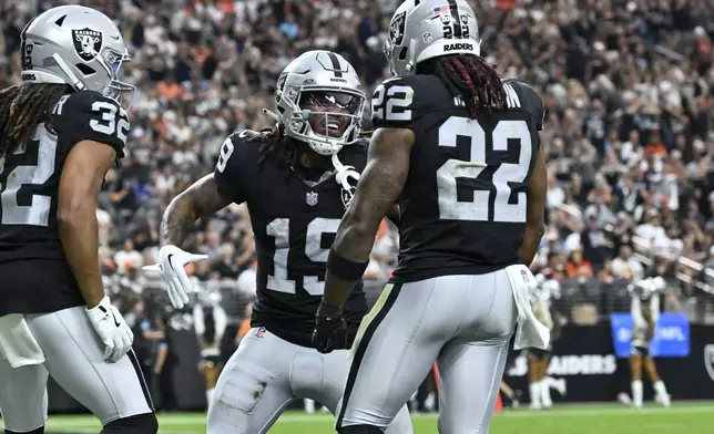 Las Vegas Raiders wide receiver DJ Turner, center, celebrates with teammates after scoring a touchdown during the second half of an NFL football game against the Cleveland Browns Sunday, Sept. 29, 2024, in Las Vegas. (AP Photo/David Becker)