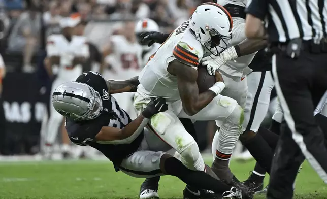 Cleveland Browns quarterback Deshaun Watson is hauled down for a sack by Las Vegas Raiders safety Isaiah Pola-Mao during the second half of an NFL football game Sunday, Sept. 29, 2024, in Las Vegas. (AP Photo/David Becker)