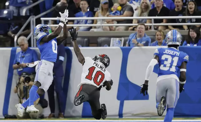 Detroit Lions cornerback Terrion Arnold (0) deflects a pass intended for Tampa Bay Buccaneers wide receiver Trey Palmer (10) but is called for pass interference during the first half of an NFL football game, Sunday, Sept. 15, 2024, in Detroit. (AP Photo/Duane Burleson)